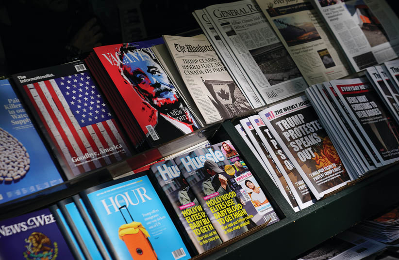 A newsstand in Manhattan outfitted with ‘Fake News’ headlines was a stunt by the ‘Columbia Journalism Review,’ in October 2018. (photo credit: CARLO ALLEGRI/REUTERS)