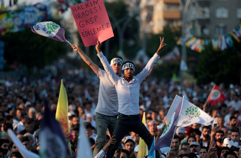 FILE PHOTO: Supporters of the pro-Kurdish Peoples' Democratic Party (HDP) wave party flags during a peace day rally in Diyarbakir, Turkey, September 1, 2019 (photo credit: REUTERS/SERTAC KAYAR/FILE PHOTO)