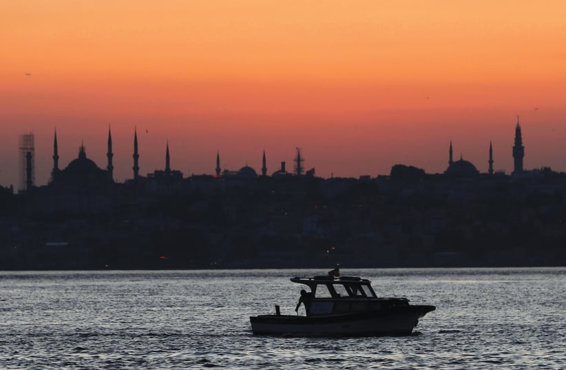 A FISHING boat sails through Istanbul (photo credit: REUTERS)