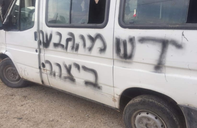 Hebrew words which read 'regards from Yitzhar' spray-painted by vandals are seen on a vehicle in the West Bank village of Yatma (photo credit: B’TSELEM)