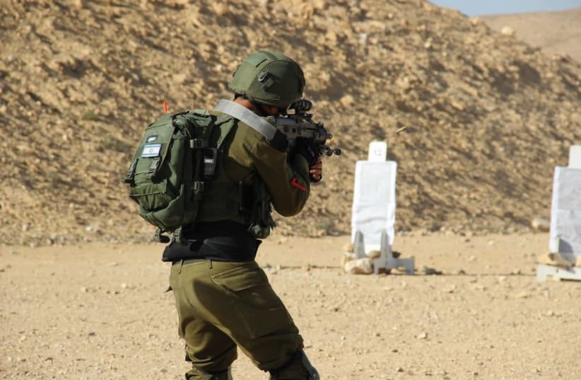 “A” in his uniform during shooting practice in the IDF (photo credit: IDF SPOKESPERSON'S UNIT)