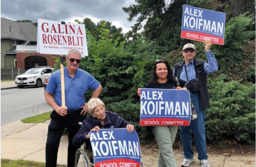 Holding a sign with Koifman's name on (photo credit: Courtesy)