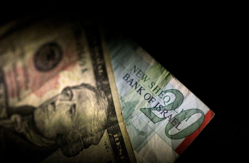 Shekels and dollars (photo credit: THOMAS WHITE / REUTERS)