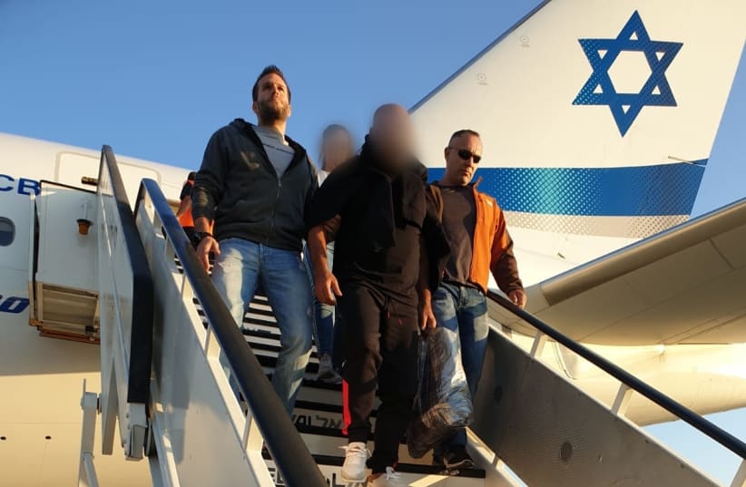 58-year-old Israeli suspect extradited from Thailand, to be questioned for involvement in assault of multiple minors (photo credit: ISRAEL POLICE)