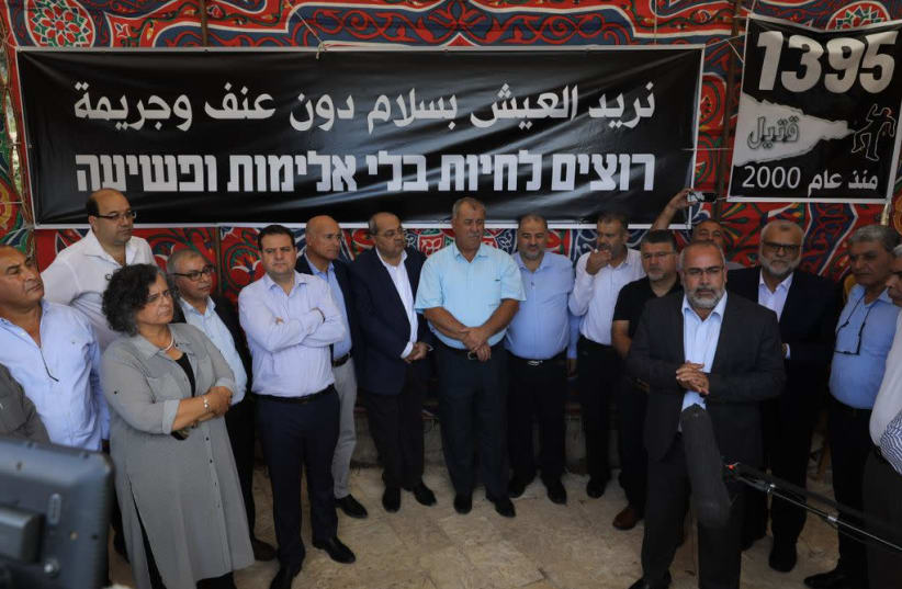 Arab leaders stand in front of a sign that reads "We want to live without violence and crime" (photo credit: MARC ISRAEL SELLEM)