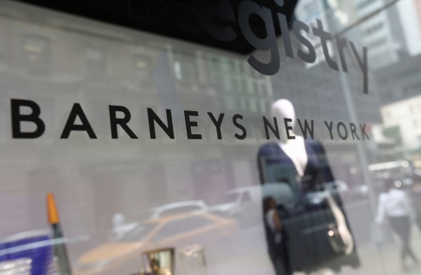 Barneys New York sign is seen in a display window outside the luxury department store (photo credit: SHANNON STAPLETON/ REUTERS)