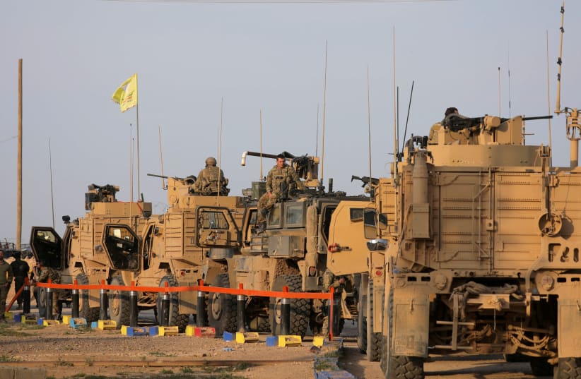 American soldiers stand near military trucks, at al-Omar oil field in Deir Al Zor (photo credit: REUTERS/RODI SAID)