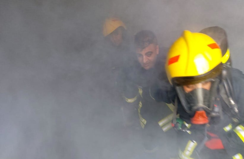 Israeli and Palestinian firefighters practice saving lives together (photo credit: COGAT)