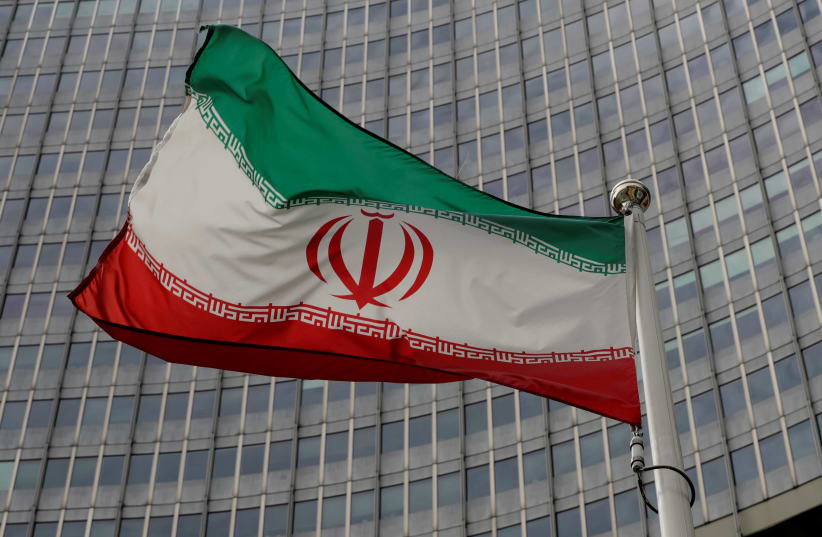 An Iranian flag flutters in front of the International Atomic Energy Agency (IAEA) headquarters in Vienna, Austria September 9, 2019 (photo credit: REUTERS/LEONHARD FOEGER)