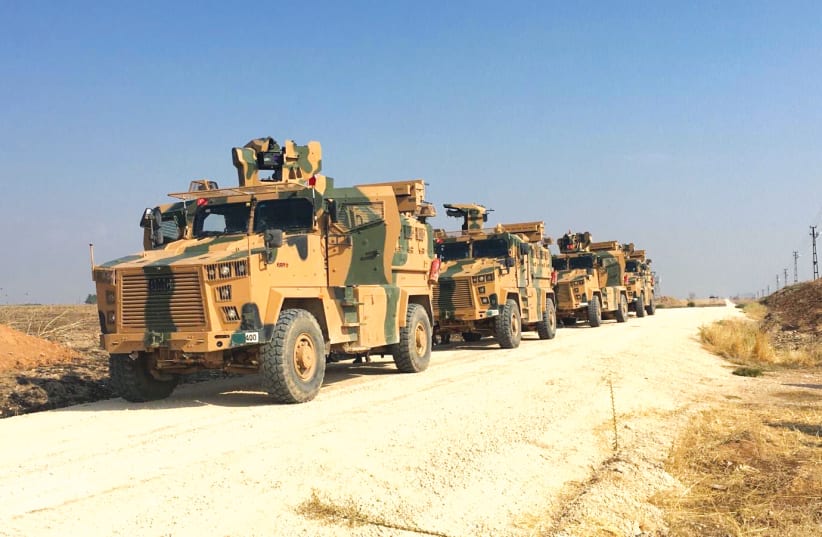 TURKISH MILITARY vehicles are seen on the Turkish-Syrian border before a joint Turkish-Russian patrol in northeast Syria, near the Turkish town of Kiziltepe. (photo credit: REUTERS)