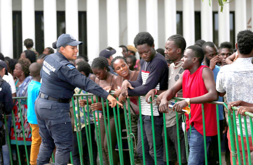 AFRICAN MIGRANTS wait to be admitted outside of Siglo XXI migration facility in Mexico in June (photo credit: JOSE CABEZAS/REUTERS)