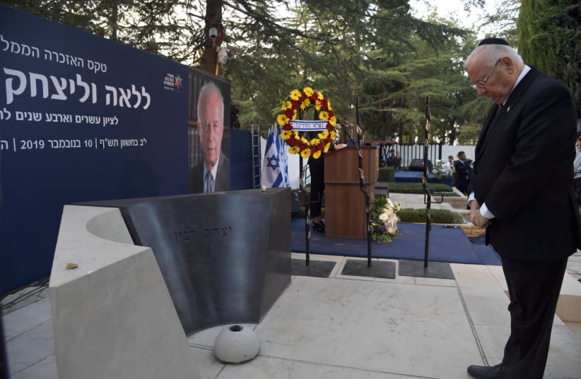 President Reuven Rivlin pays his respects to former prime minister Yitzhak Rabin at the latter's memorial ceremony. (photo credit: HAIM ZACH/GPO)