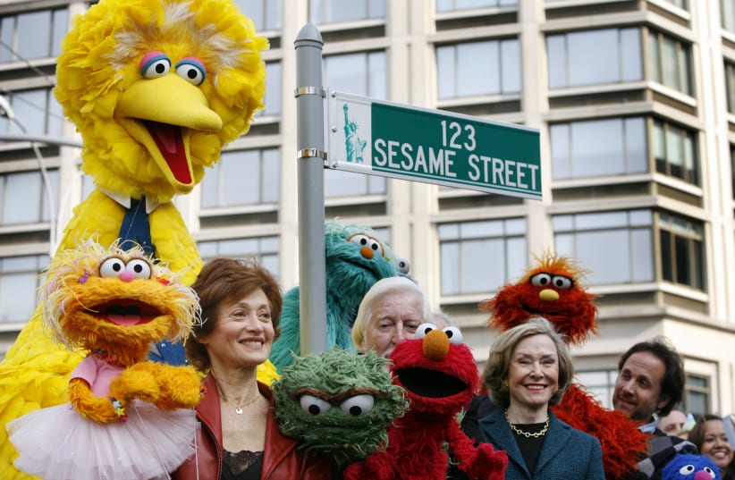 Sesame Street creator Joan Ganz Cooney poses with some of the cast during a 40th anniversary street naming celebration in New York (photo credit: SHANNON STAPLETON/ REUTERS)
