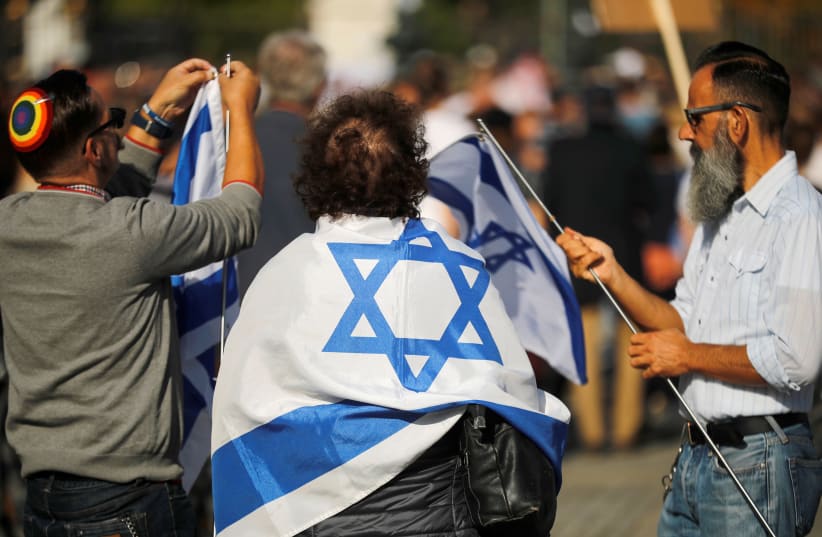 People attend a demonstration themed with the slogan "#unteilbar" (indivisible) to protest against antisemitism, racism and nationalism in Berlin, Germany, October 13, 2019 (photo credit: HANNIBAL HANSCHKE/REUTERS)