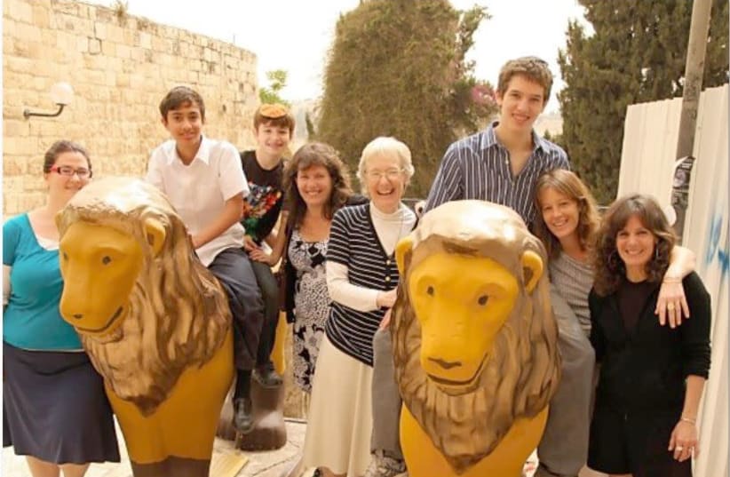 Family Menagerie: the writer and her family surround the Sister Lions (photo credit: Courtesy)