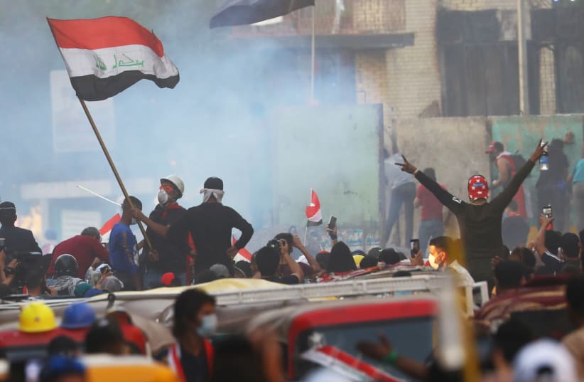 Iraqi demonstrators take part in ongoing anti-government protests in Baghdad, Iraq November 15, 2019. (photo credit: THAIER AL-SUDANI/REUTERS)