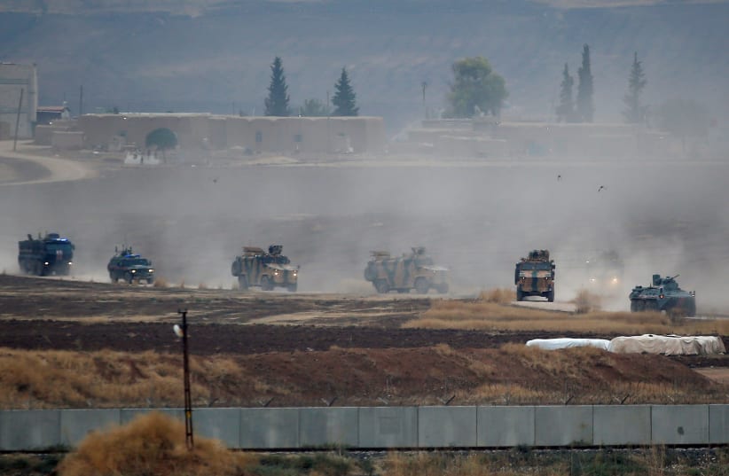 Turkish and Russian military vehicles return following a joint patrol in northeast Syria, as they are pictured near the Turkish border town of Kiziltepe in Mardin province, Turkey, November 1, 2019 (photo credit: REUTERS/KEMAL ASLAN)