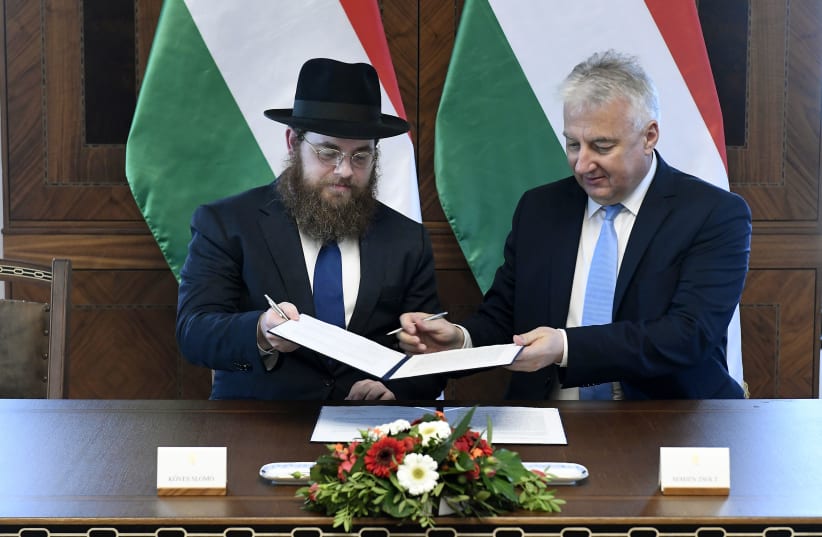 Hungarian Deputy Prime Minister Zsolt Semjén and Rabbi Shlomo Koves, head of the EMIH sign a special agreement, November 18, 2019 (photo credit: MTI)