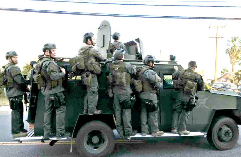 A POLICE SWAT team conducts a manhunt after a mass shooting in San Bernadino, California, on December 2, 2015 (photo credit: REUTERS)