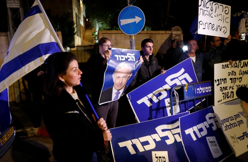 Supporters of Israeli Prime Minister Benjamin Netanyahu protest outside his residence following Israel's Attorney General Avichai Mandelblit's indictment ruling in Jerusalem (photo credit: RONEN ZVULUN / REUTERS)