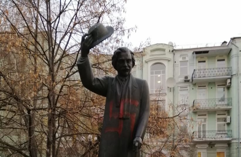 A statue to prominent Yiddish writer Sholom Aleichem in Kiev was found defaced by swastikas on November 25, 2019. (photo credit: COURTESY OF MOSHE REUVEN AZMAN)