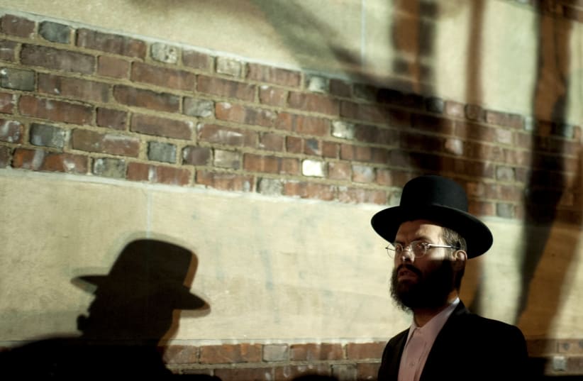 A man arrives at a mass gathering of Satmar Hasidic Jews in the Brooklyn borough of New York December 2, 2015 (photo credit: REUTERS/DARREN ORNITZ)