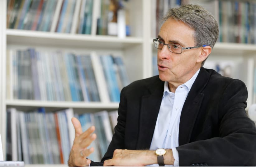 Human Rights Watch Executive Director Kenneth Roth speaks during a interview with Reuters in Geneva, Switzerland, April 9, 2018 (photo credit: REUTERS/PIERRE ALBOUY)
