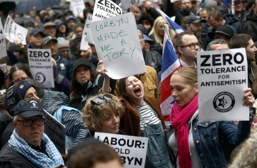 Demonstrators take part in an antisemitism protest outside the Labour Party headquarters in central London in 2018 (photo credit: REUTERS/SIMON DAWSON)