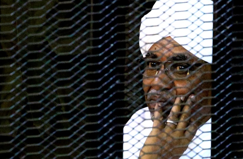 Sudan's former president Omar Hassan al-Bashir sits inside a cage at the courthouse where he is facing corruption charges, in Khartoum, Sudan September 28, 2019 (photo credit: REUTERS/MOHAMED NURELDIN ABDALLAH)