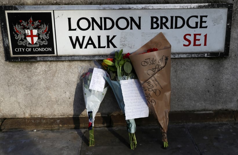 Flowers are left at the scene of a stabbing on London Bridge (photo credit: REUTERS)