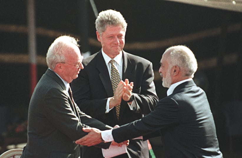 THEN-US PRESIDENT BILL Clinton applauds then-prime minister Yitzhak Rabin and Jordan’s King Hussein after the peace treaty signing ceremony at the Arava Crossing between the two countries on October 26, 1994 (photo credit: REUTERS)