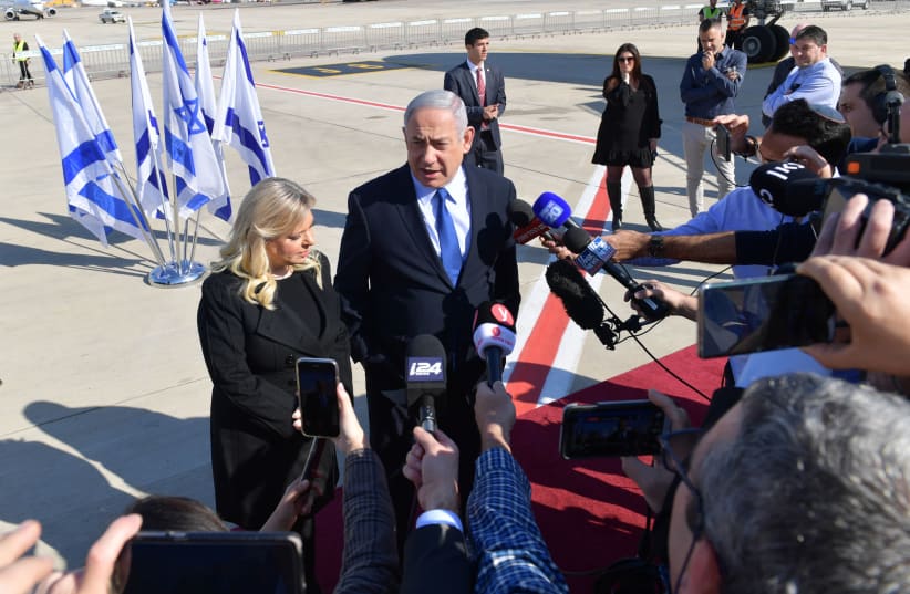 Prime Minister Benjamin Netanyahu and his wife Sara speak to the press before boarding the plane to Lisbon (photo credit: KOBI GIDEON/GPO)