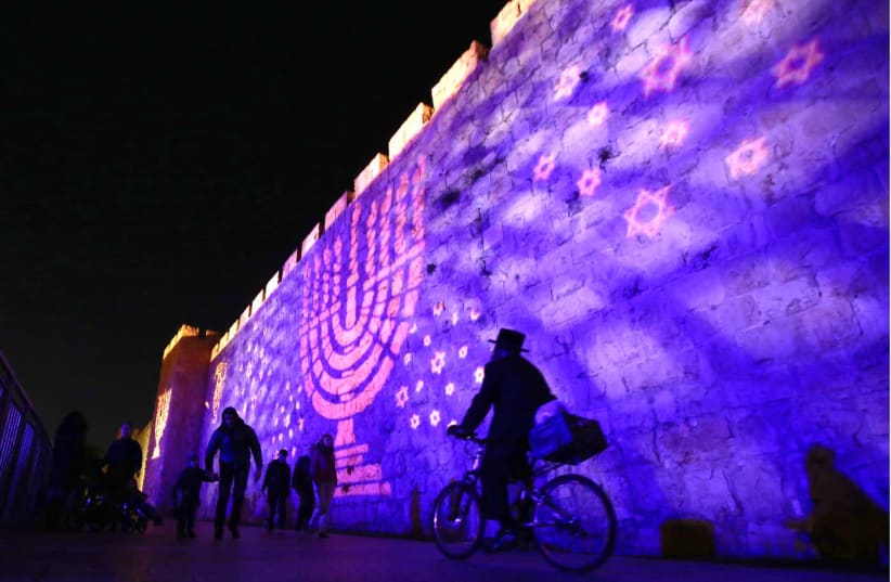 HANUKKAH IMAGES illuminate Jerusalem’s Old City walls.  (photo credit: MARC ISRAEL SELLEM)