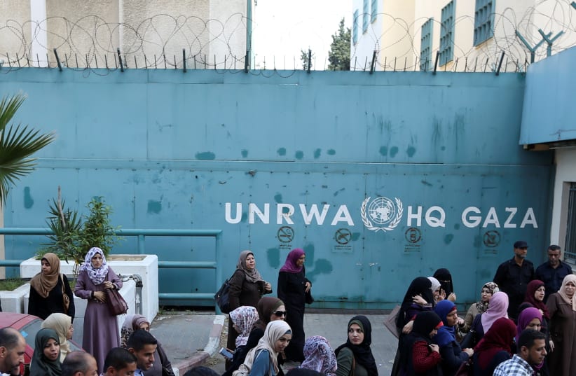 Palestinian employees of United Nations Relief and Works Agency (UNRWA) take part in a protest against job cuts by UNRWA, in Gaza City September 19, 2018.  (photo credit: REUTERS/IBRAHEEM ABU MUSTAFA)