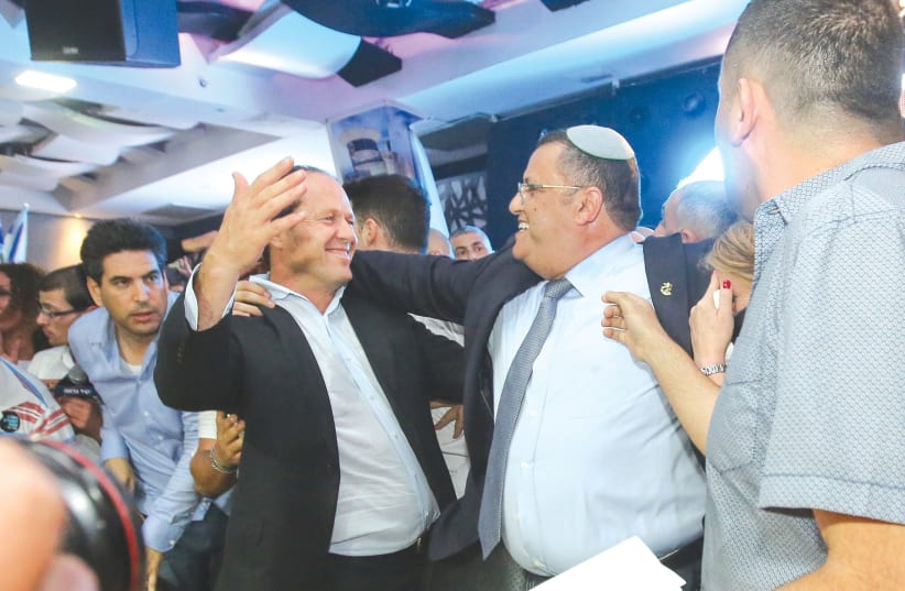 JERUSALEM MAYOR Moshe Lion (right) is congratulated by his predecessor, Nir Barkat (photo credit: MARC ISRAEL SELLEM/THE JERUSALEM POST)