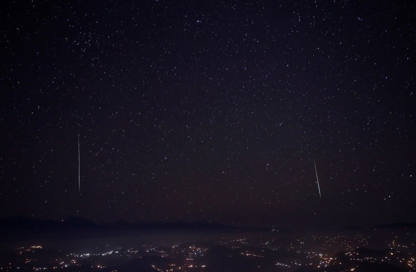 A Geminids meteor shower is seen above the mountain range in Nagarkot. 2017 (photo credit: NAVESH CHITRAKAR/REUTERS)