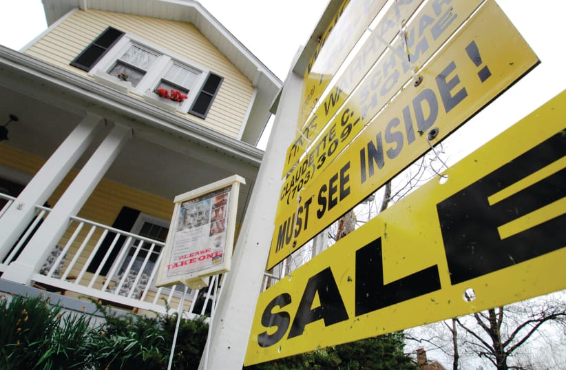A SIGN advertises an open house for sale in Alexandria, Virginia. (photo credit: JONATHAN ERNST / REUTERS)