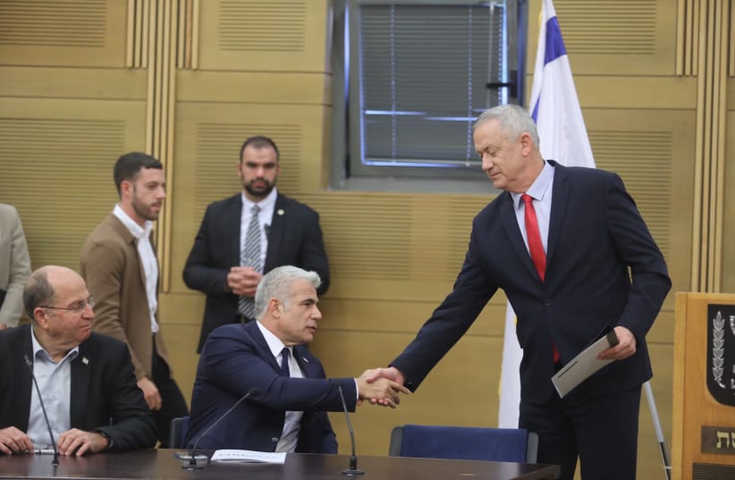 Blue and White leader Benny Gantz shakes hands with Blue and White MK Yair Lapid (photo credit: MARC ISRAEL SELLEM/THE JERUSALEM POST)