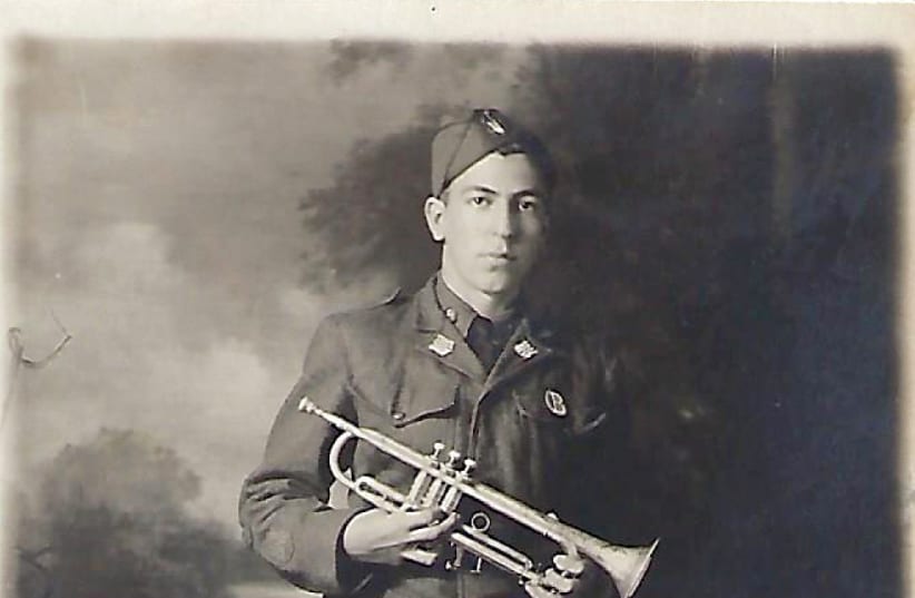 A young David Amato attempting to learn how to play the trumpet, despite an injured right hand (photo credit: Courtesy)