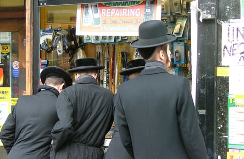 Ultra-Orthodox Jews stand in a street in the predominantly Jewish neighborhood of Stamford Hill in the UK (photo credit: Wikimedia Commons)