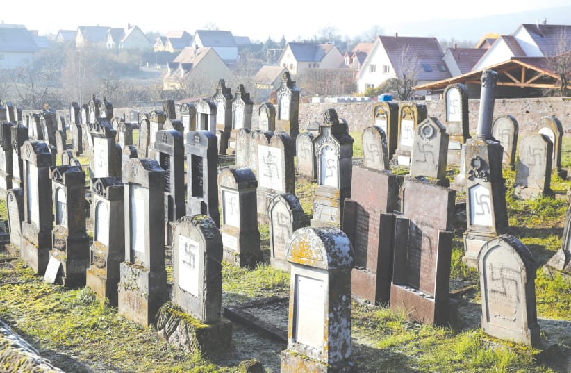 GRAVES DESECRATED with swastikas are seen at the Jewish cemetery in Westhoffen, near Strasbourg, France. (photo credit: REUTERS)