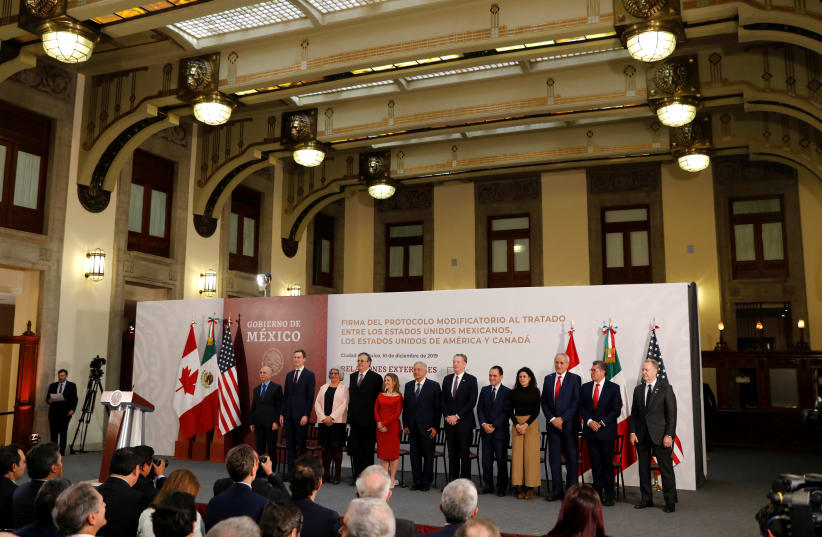 Mexico's President Andres Manuel Lopez Obrador, Canadian Deputy Prime Minister Chrystia Freeland and U.S. Trade Representative Robert Lighthizer pose next to other representatives during a meeting at the Presidential Palace, in Mexico City, Mexico December 10, 2019 (photo credit: REUTERS/CARLOS JASSO)
