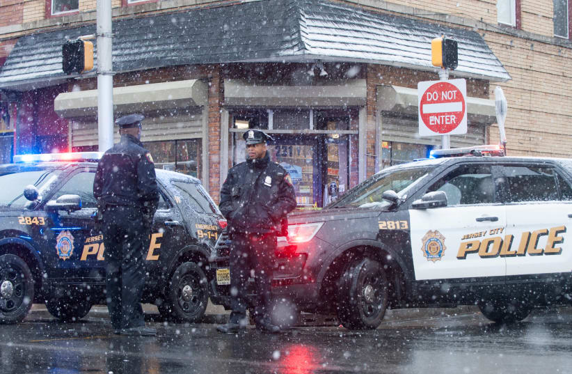 Jersey City police work at the scene the day after an hours-long gun battle with two men around a kosher market in Jersey City, New Jersey (photo credit: REUTERS/LLOYD MITCHELL)