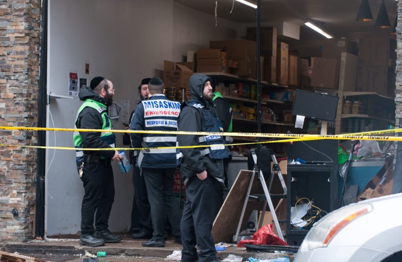 Emergency personnel and investigators work at the scene the day after an hours-long gun battle with two men around a kosher market in Jersey City, New Jersey, U.S., December 11, 2019 (photo credit: REUTERS/LLOYD MITCHELL)