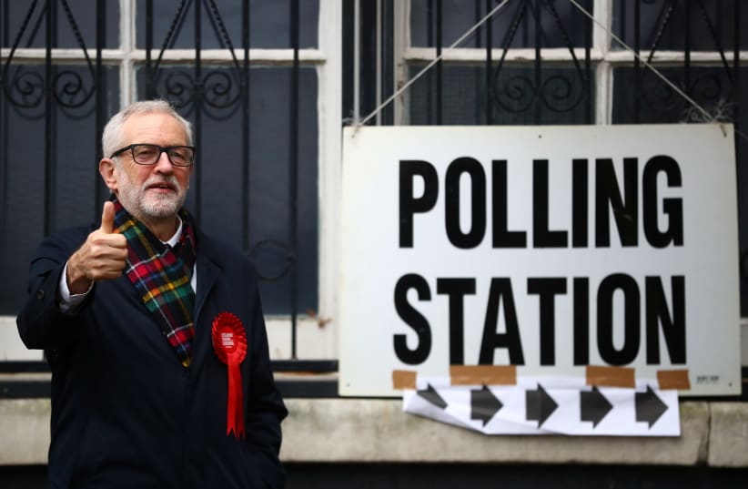 Britain's opposition Labour Party leader Jeremy Corbyn poses outside a polling station after voting in the general election in London, Britain, December 12, 2019 (photo credit: REUTERS/HANNAH MCKAY)