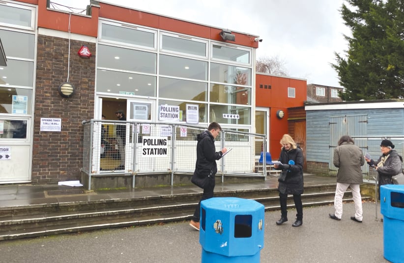 VOTERS AND TELLERS outside a polling station inside Menorah Primary School in Golders Green, London. (photo credit: JOSH DELL)