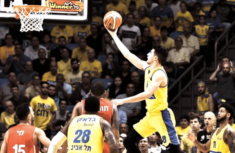 MACCABI TEL AVIV’S Deni Avdija (with ball) has shown glimpses of his immense talent this season, and the 18-year-old swingman is set to start playing more of a key role for the team with a spike of injuries to the roster. (photo credit: DOV HALICKMAN PHOTOGRAPHY)