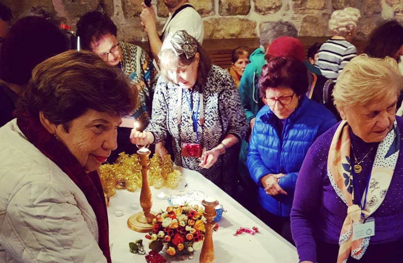 Romanian Holocaust survivors light candles as they celebrate their bat mitzvah at the Western Wall. (photo credit: ILANIT CHERNICK)