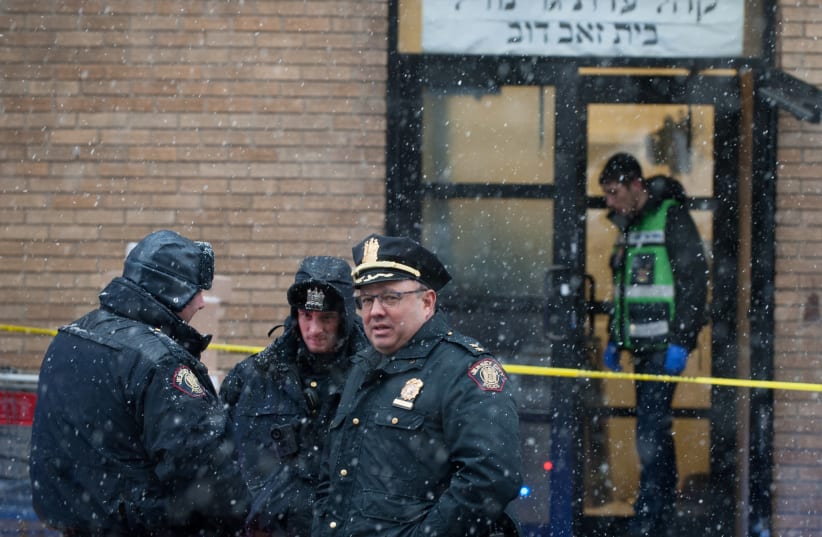 Emergency personnel and investigators work at the scene the day after an hours-long gun battle with two men around a kosher market in Jersey City, New Jersey, U.S., December 11, 2019. (photo credit: REUTERS/LLOYD MITCHELL)