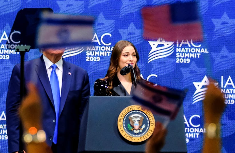 US President Donald Trump stands next to a former student of New York University speaking at the Israeli-American Council Summit in Hollywood, Florida, U.S. December 7, 2019 (photo credit: REUTERS/MARIA ALEJANDRA CARDONA)